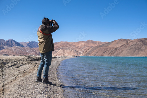 Photography Photographer takes photo at Pangong lake, Ladakh, India.