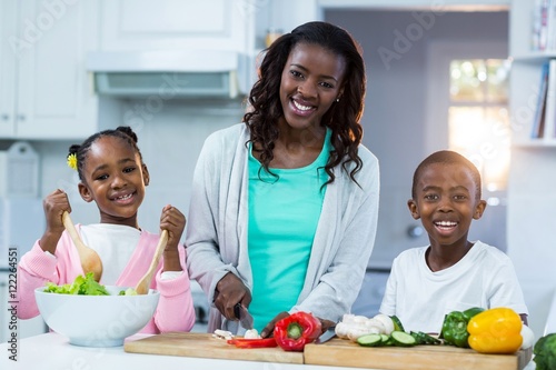 Portrait of mother with their children preparing food