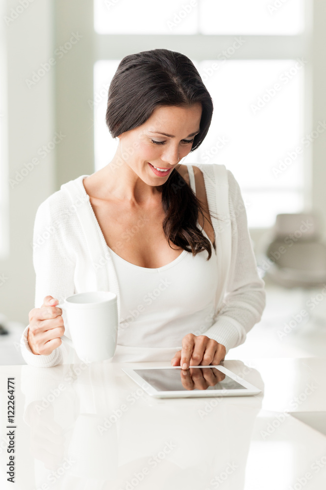 Young woman with digital tablet and coffee in home Young woman with digital tablet and coffee in home