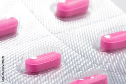 Pink antihistamine allergy benadryl tablets in blister pack close up photo