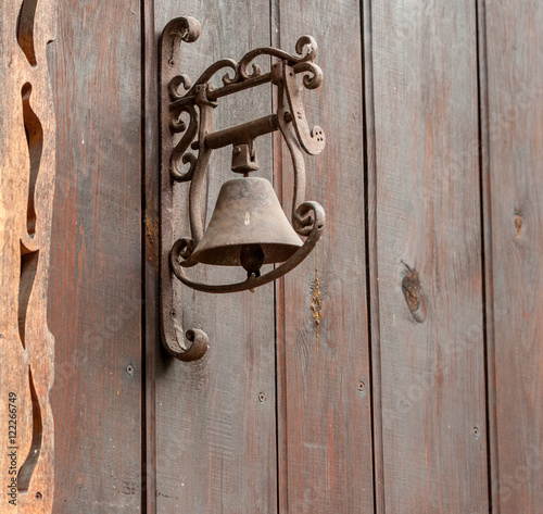 an old door bell on wooden background