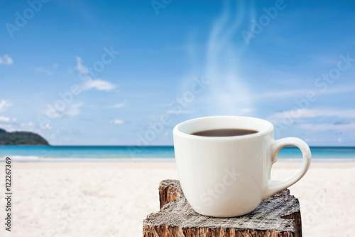hot coffee white cup over tropical blue sea on day noon light.