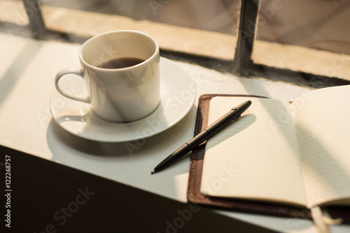 Blank leather journal and coffee