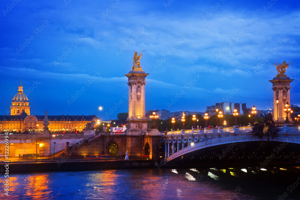 Alexandre III Bridge at night in Paris, France toned