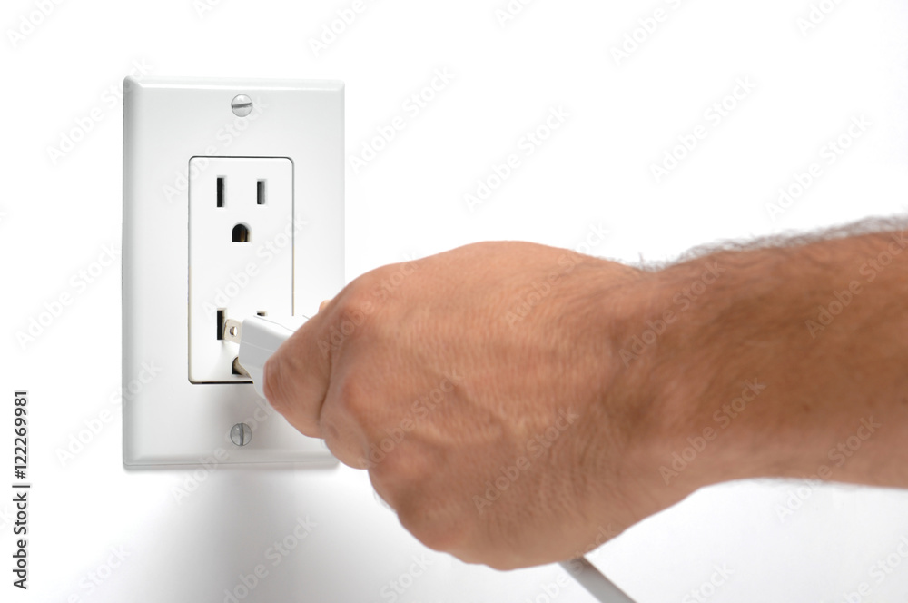 Man unplugging electrical cords on white Man unplugging electrical cords on white