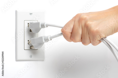 Εκτύπωση καμβά Woman's hand yanking pulling unplugging electrical cords isolated on white backg
