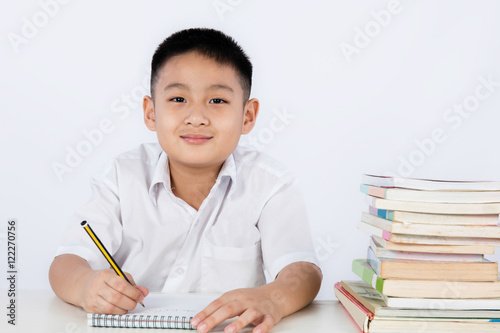 Asian Chinese Little Boy Wearing Student Uniform Writting Homewo