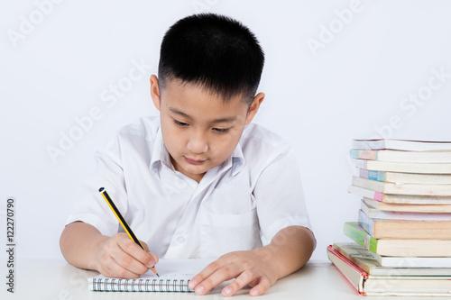 Asian Chinese Little Boy Wearing Student Uniform Writting Homewo photo