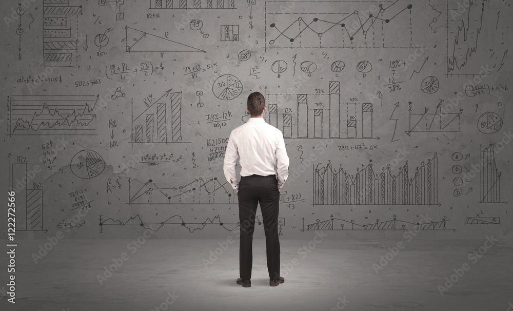 Salesman with business charts on wall Salesman with business charts on wall