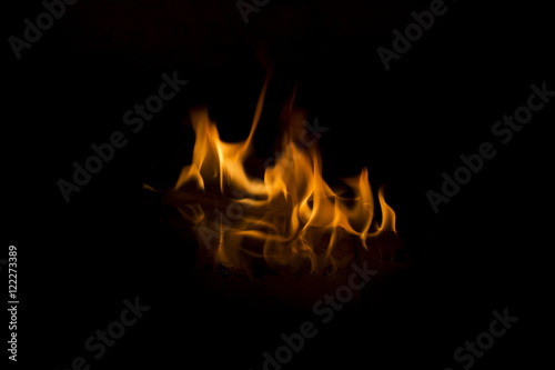 Fire flames on black background with reflection