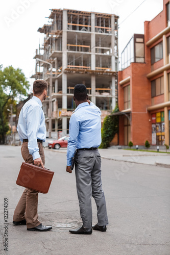 two businessmen discussing a construction project 