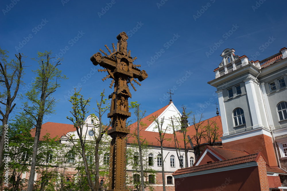 Fototapeta premium Openwork wooden cross in the monastery courtyard