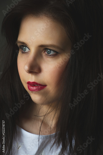 Beautiful Brunette Girl. portrait woman low key. closeup. dark background