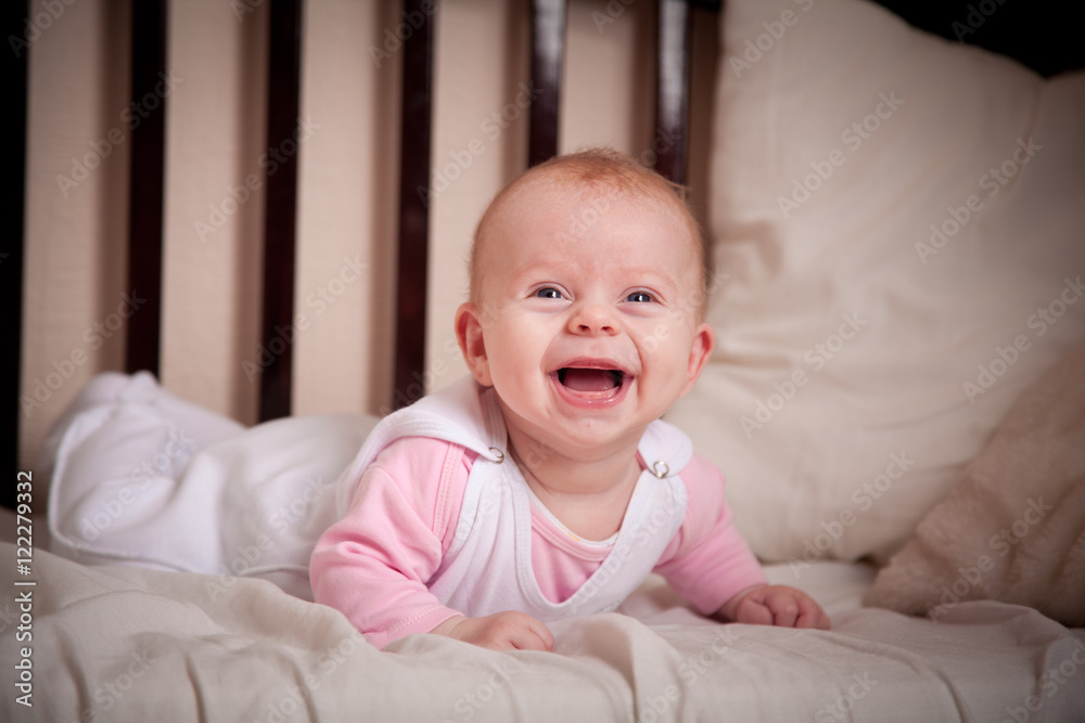 Happy baby lying on the bed Happy baby lying on the bed