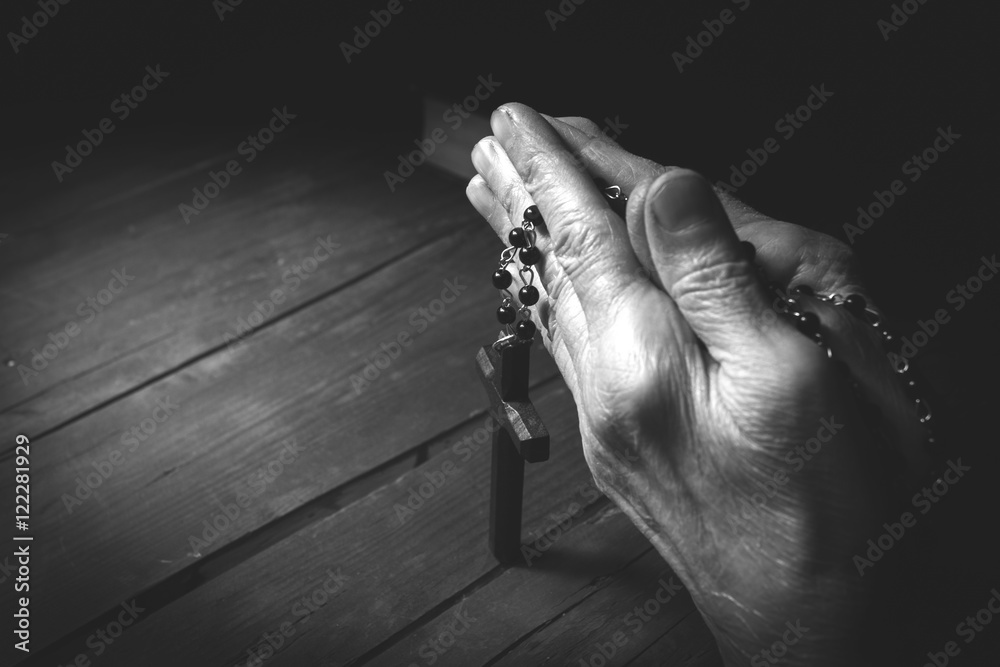 Hands holding rosary beads and cross while praying. Stock Photo | Adobe ...