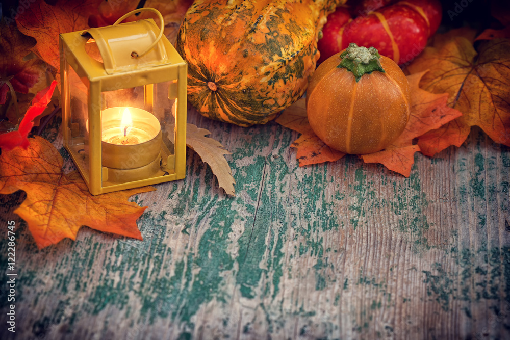Autumn background with pumpkin and lantern on wooden table - obrazy, fototapety, plakaty 
