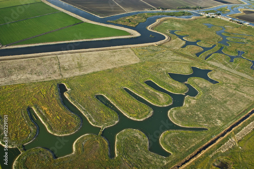 Agriculture - Aerial view of farmland, both cultivated and fallow, and river channels in the Sacramento-San Joaquin River Delta / near Lodi, California, USA.