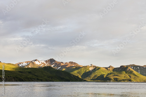 Mountains And A Town Along The Coastline On Unimak Island; False Pass, Alaska, United States Of America photo