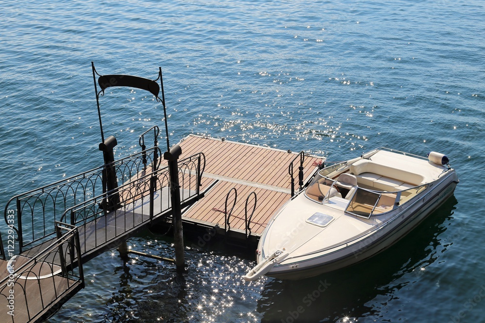 A luxury motor boat in a pontoon in Lake Como, near Bellagio, Italy. A luxury motor boat in a pontoon in Lake Como, near Bellagio, Italy.