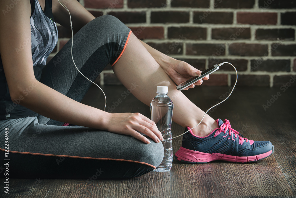 take rest listening to music drinking water after fitness exerci