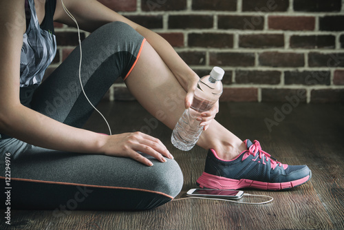 take rest listening to music drinking water after fitness exerci