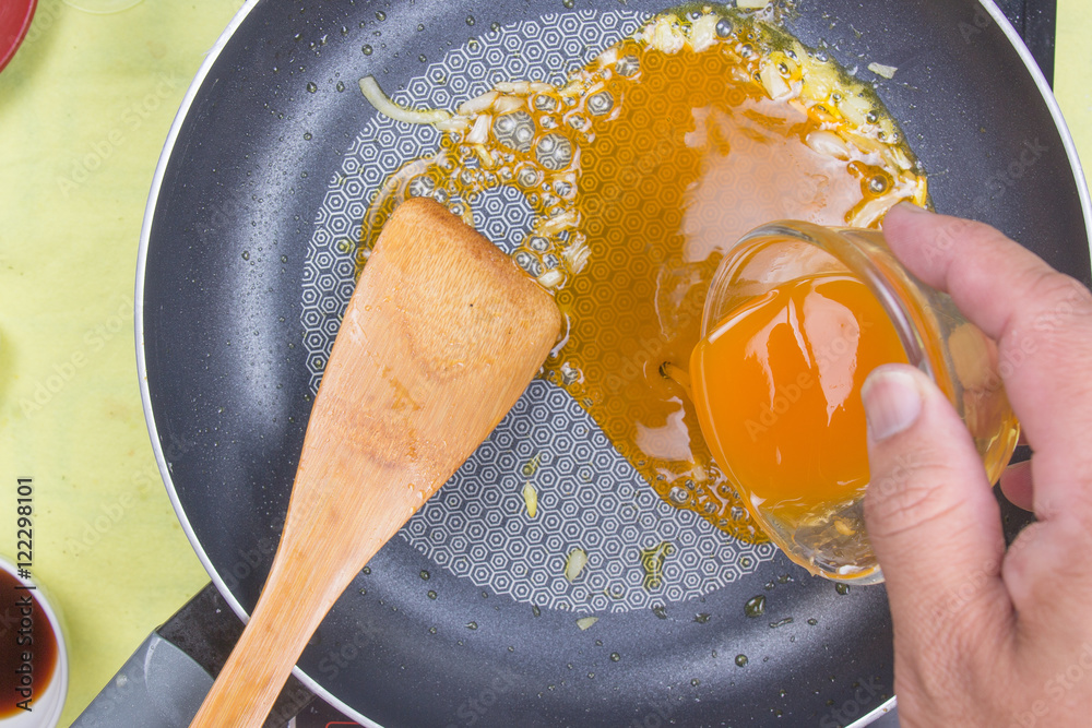 Cooking orange sauce for fish steak foto de Stock Adobe Stock