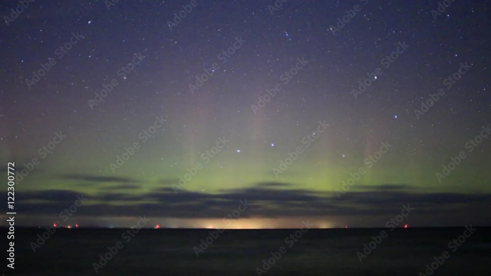 Time lapse night sky, Big Dipper Ursa Major Constellation moving with green and red light pillars from Northern Light in Ontario, Canada Time lapse night sky, Big Dipper Ursa Major Constellation moving with green and red light pillars from Northern Light in Ontario, Canada