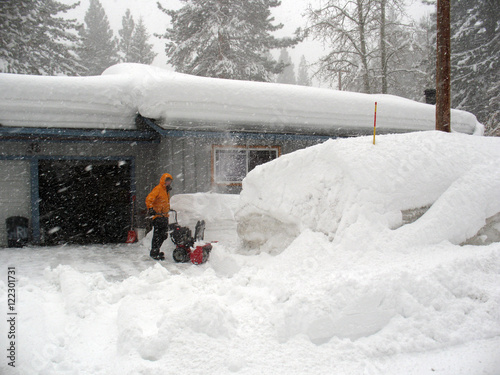 Snowblower/A person pushes a snow blower through very deep snow during a blizzard