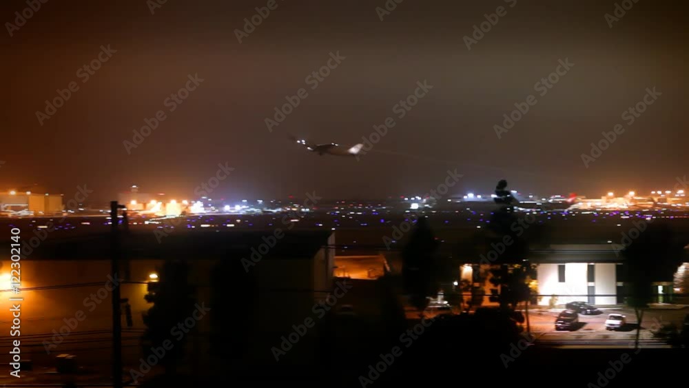 A commercial jet liner takes off from LAX at night.