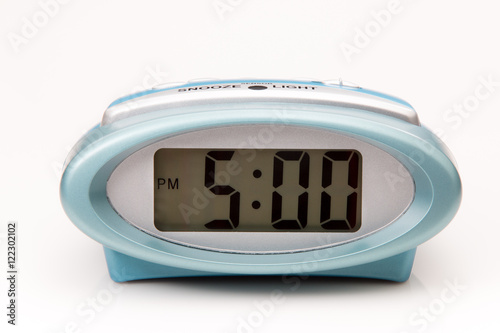 Digital clock displaying 5:00 pm on white backround