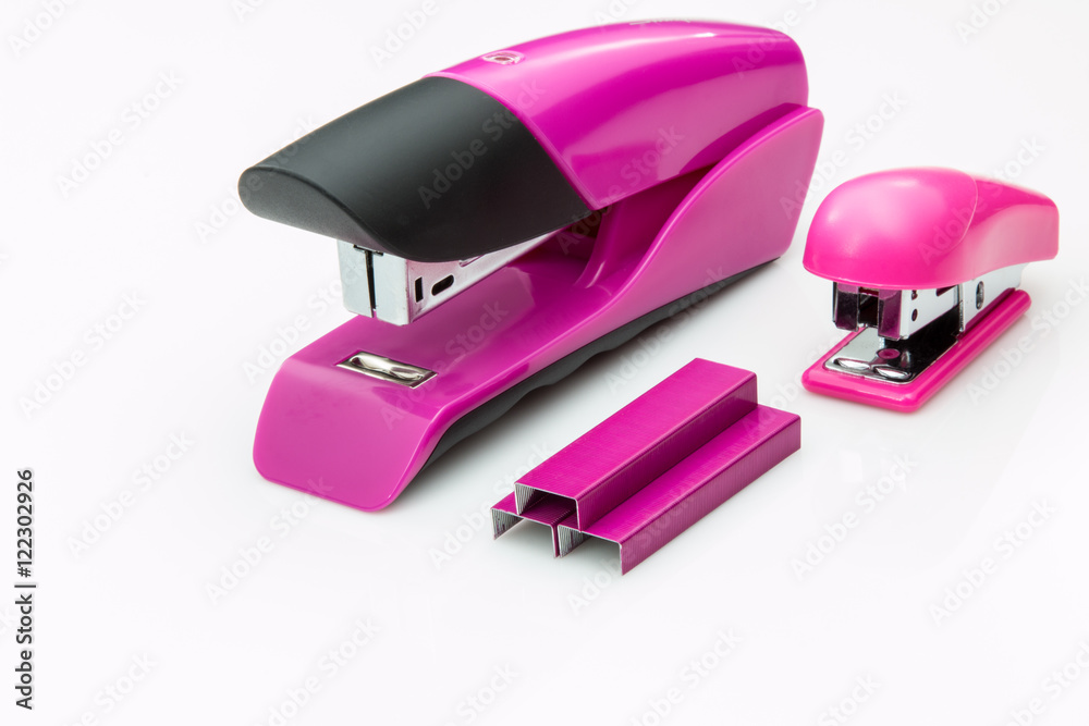 Two staplers and staples on a white background.