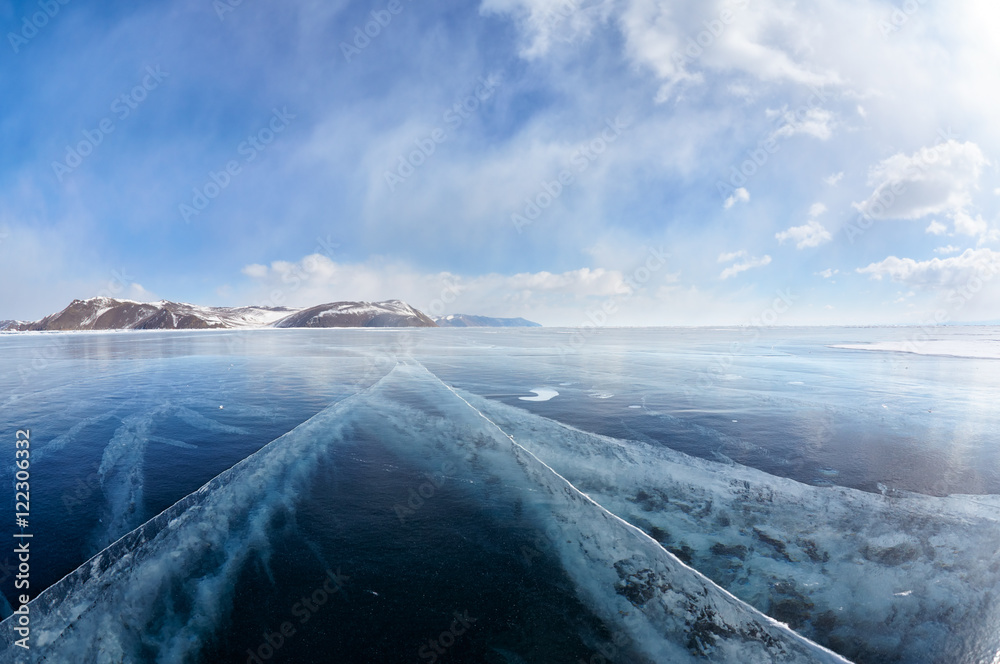 Naklejka premium Winter ice landscape on Siberian lake Baikal with clouds
