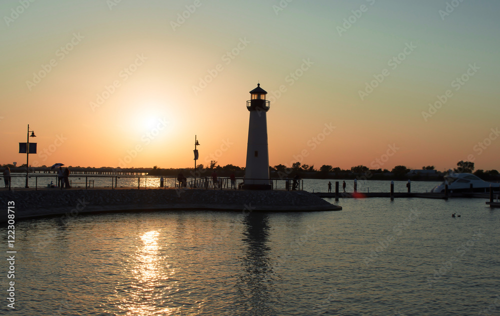 picture of boats pier lighthouse and lake in evening for backgro
