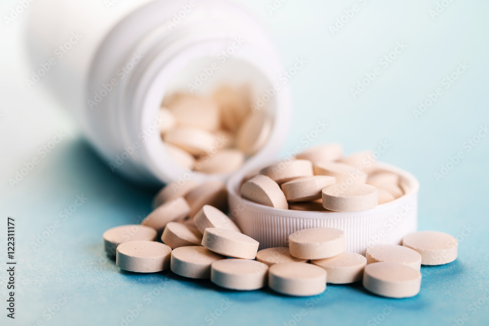 Container with pills close-up Container with pills close-up