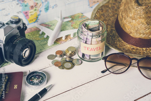 Collecting money for travel with accessories of traveler, Travel concept
