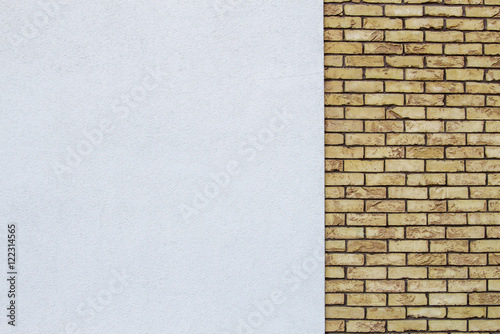 Modern brick wall with white painted plaster background