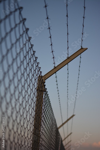 Secure fence at sunset