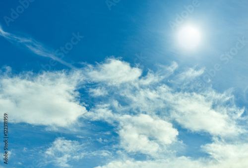 Sun with blue sky and clouds