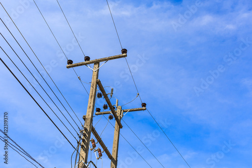 electricity post against blue sky