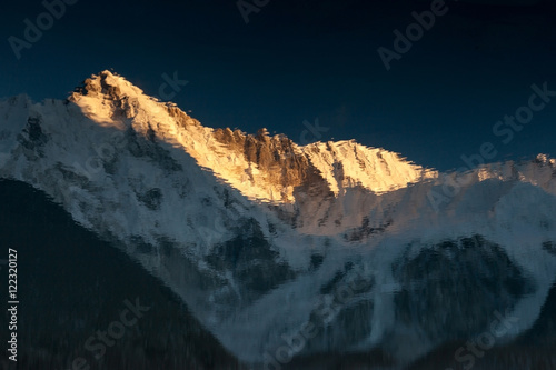 Beautiful sunset over mountain Cho Oyu reflection in the blue moraine lake mirror surface. Picturesque mountain scenery in Sagarmatha National Park, Himalayas, Nepal. photo