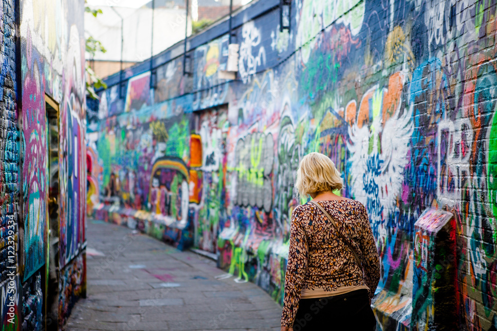 Woman walking in graffiti