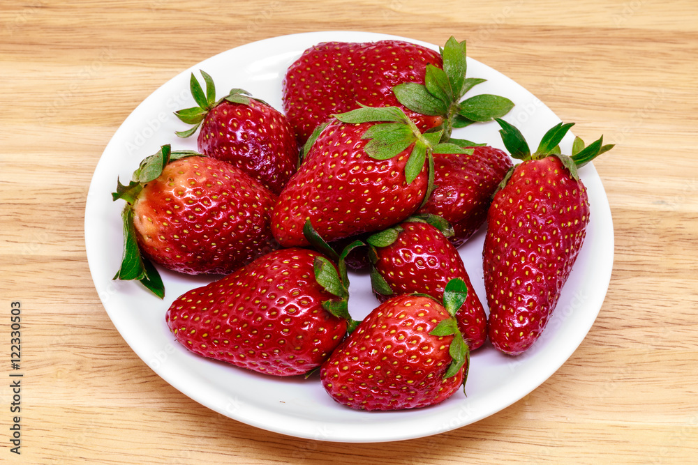 Fresh strawberry in dish on wooden background Fresh strawberry in dish on wooden background