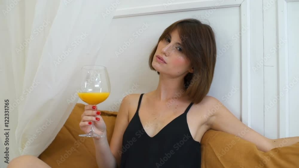 gorgeous woman drinking orange juice in luxury bedroom slow motion gorgeous woman drinking orange juice in luxury bedroom slow motion