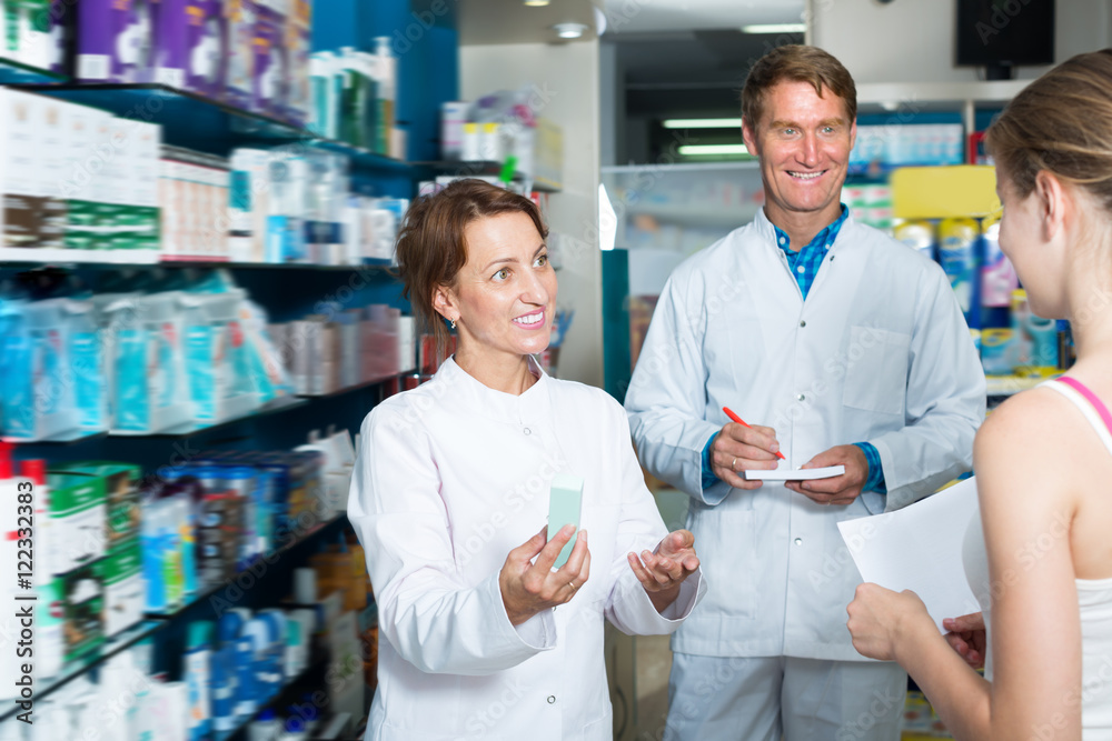 Portrait of positive man and woman pharmacists