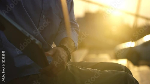 businessman working with computer at sunset