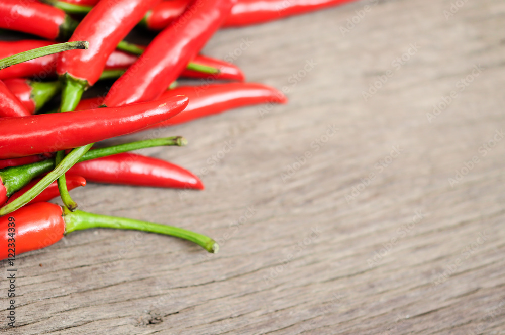 multitude of red chili peppers on wooden table, closeup view