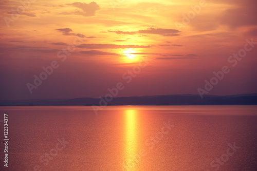 end of the day - sunset on the lake with golden reflection