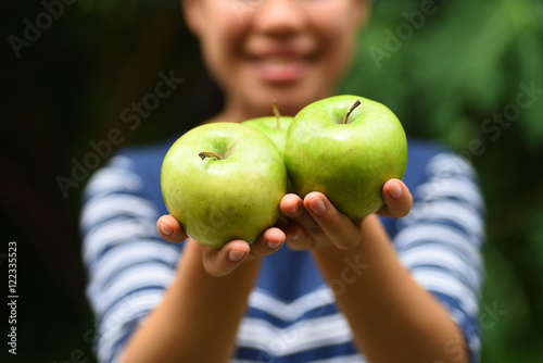 Green apple fruit holding by woman hand