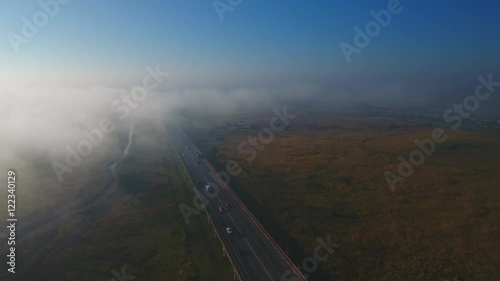 Autumn morning fog over highway. Aerial view.