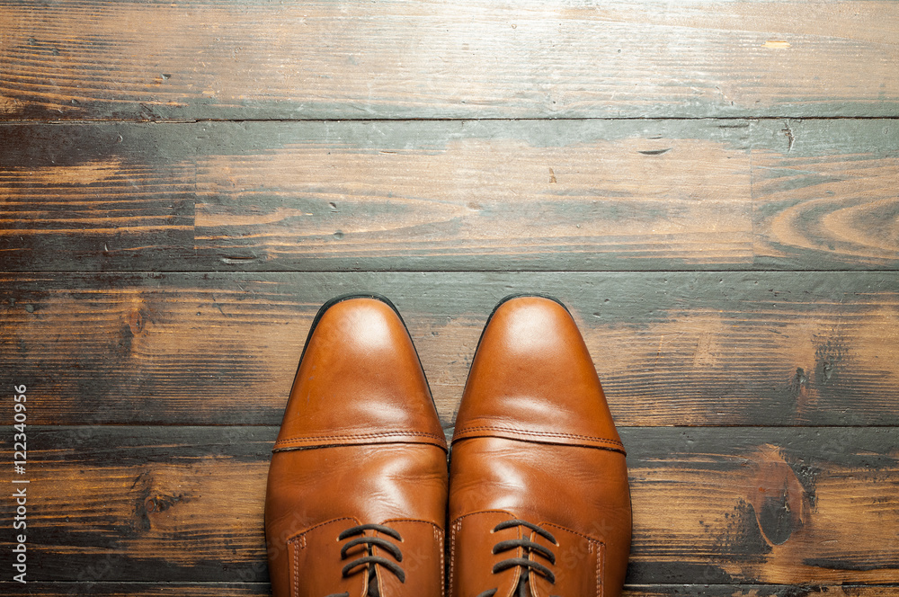 Men's leather shoes on a wooden floor